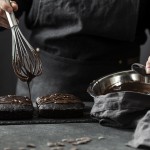 front-view-of-pastry-chef-preparing-cake-with-chocolate
